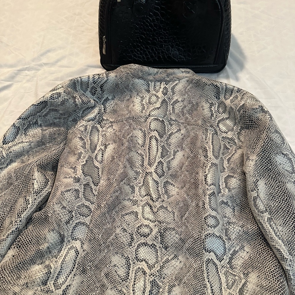 Black and white snake skin jacket with black purse